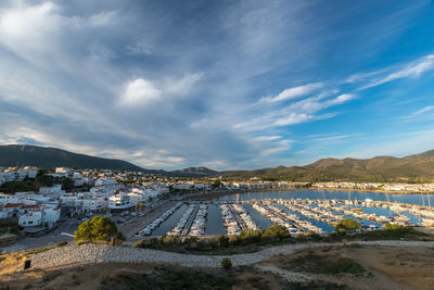 High angle view of townscape by sea against sky