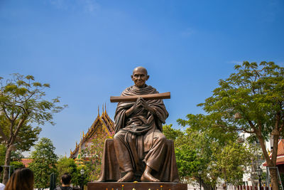 The big bronze statue of somdet budhacariya against the sky at wat rakang