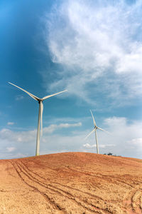 Windmill on field against sky