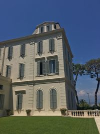 Low angle view of building against clear blue sky