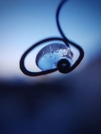 Close-up of water drop on blue surface