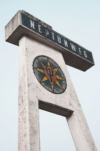 Low angle view of information sign against clear sky