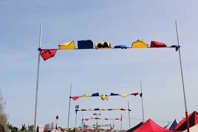 Low angle view of flags flag against sky