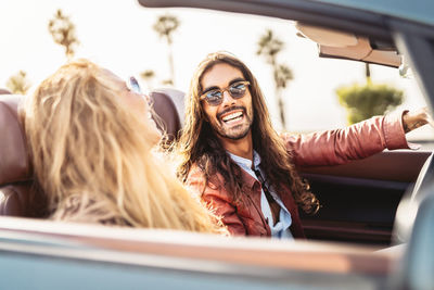 Portrait of a smiling young woman in car