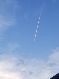 Low angle view of vapor trail in blue sky