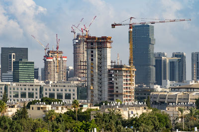 Tel aviv's skyline high rise construction with cranes and water heaters, israel