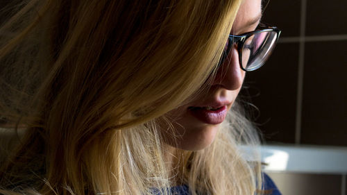 Close-up of blond woman wearing eyeglasses