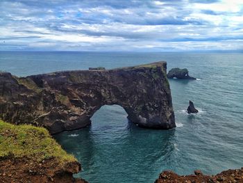 Scenic view of sea against cloudy sky