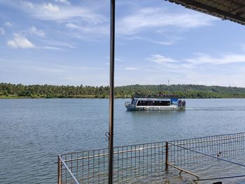 Boat sailing on river against sky