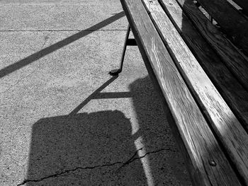 High angle view of shadow on footpath by street