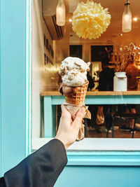 Cropped hand of woman holding ice cream cone