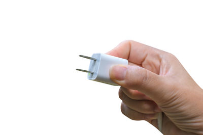 Close-up of hand holding camera over white background