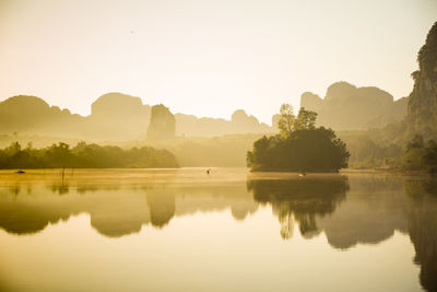 Scenic view of lake and mountains against clear sky