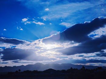 Scenic view of silhouette landscape against sky at night