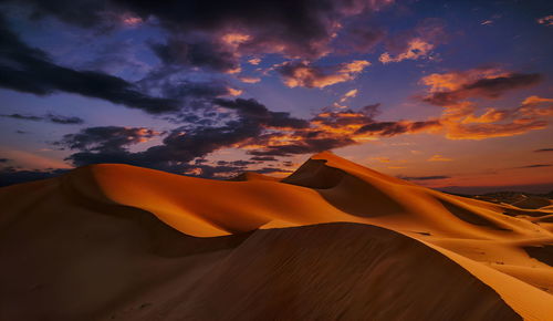 Scenic view of desert against sky during sunset