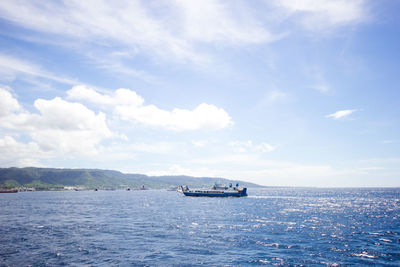 Boat sailing in sea against sky