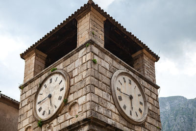 Low angle view of clock tower against sky