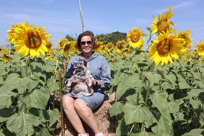 Young woman with dog holding flower