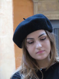 Portrait of a beautiful young woman against wall