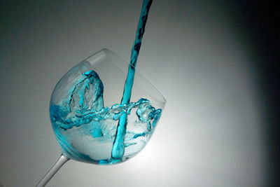 Close-up of blue liquid poured into wineglass