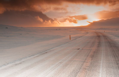 Scenic view of desert against sky during sunset