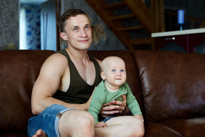 Portrait of happy family sitting at home