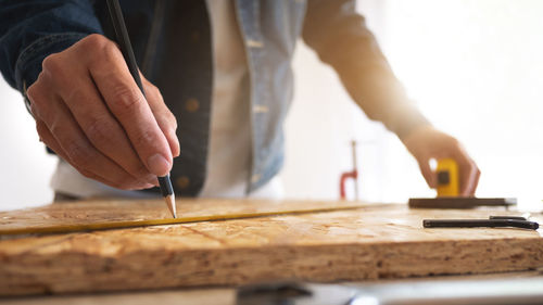 Close-up of man working on wood