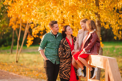 Rear view of people at park during autumn