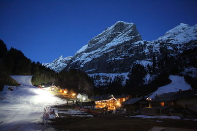 Scenic night view of snowcapped mountains against sky