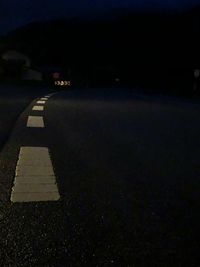 Empty road in city at night