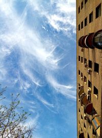 Low angle view of building against cloudy sky