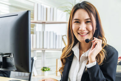 Portrait of smiling young woman using mobile phone
