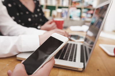 Midsection of woman using mobile phone