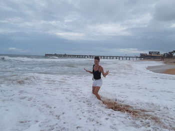 Woman on beach against sky