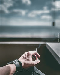 Cropped hand of man holding cigarette