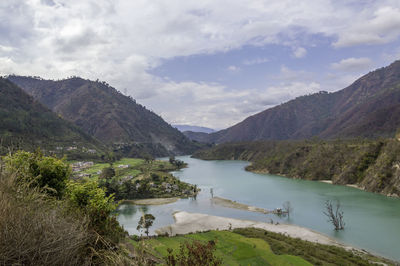 Scenic view of lake and mountains against sky