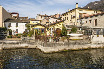 Beautiful houses reflecting on the water of the lake on the lakefront of salò