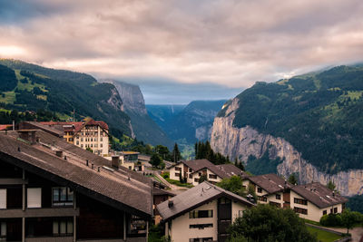 Town by mountains against sky