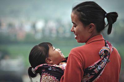 Happy mother and daughter at park