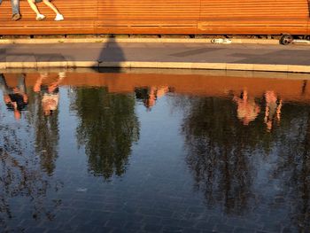 Reflection of building in puddle on lake