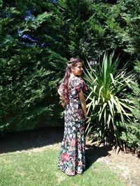 Girl standing against tree