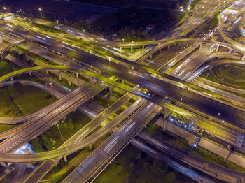 Aerial view of light trails on road in city