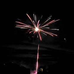 Low angle view of firework display at night