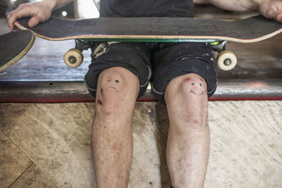 Young man holding a skateboard.