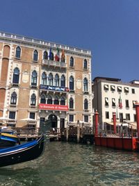 Boats in canal along buildings