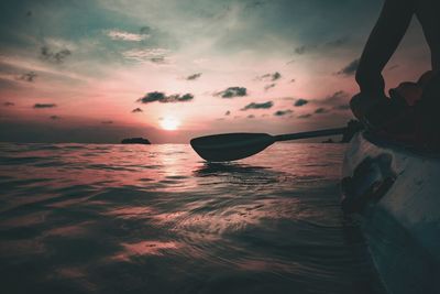 Silhouette boat in sea against sky during sunset