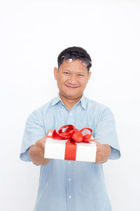 Portrait of a smiling man wearing mask against white background