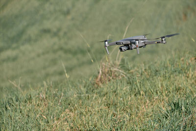 Airplane flying over grassy field