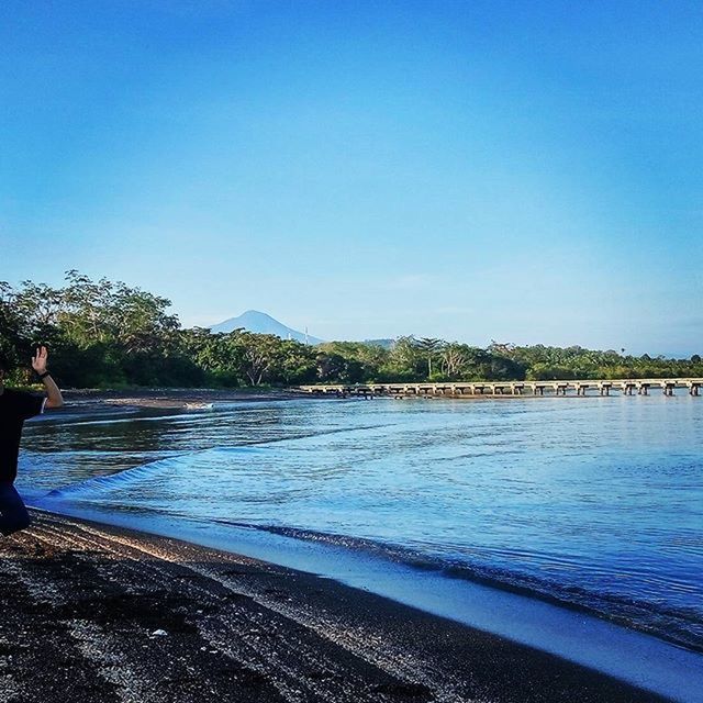 clear sky, water, copy space, blue, tranquil scene, tree, tranquility, scenics, beauty in nature, nature, lake, beach, sea, idyllic, river, shore, outdoors, day, sunlight, calm