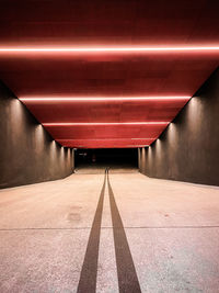 Empty road in illuminated tunnel